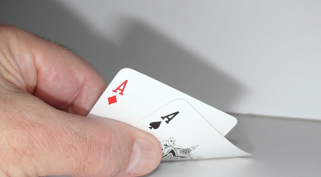 Image of someone showing a pair of aces